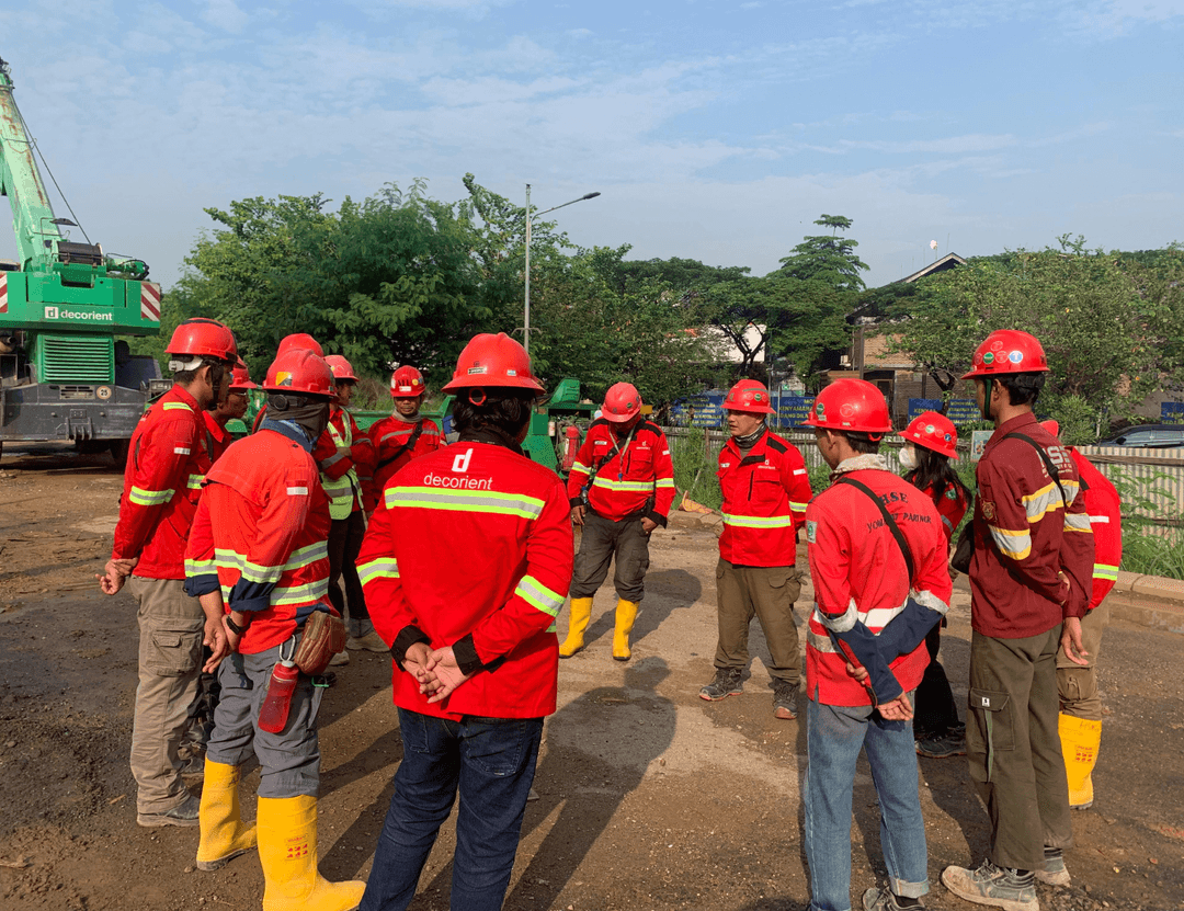Workers in red safety gear